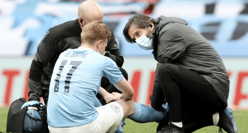 Football player receiving medical treatment for a high ankle sprain injury