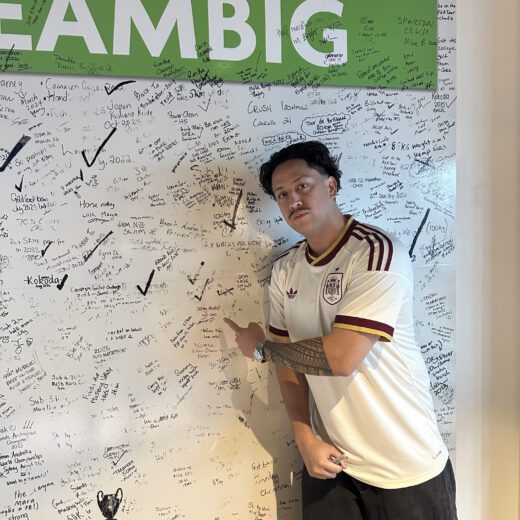 Corey Quinlan-Athlete standing beside a PEAK Dream Big wall during rehabilitation