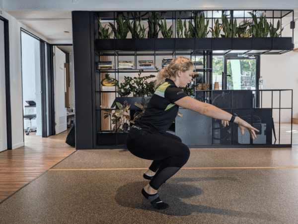 Deep squat assessment showing ankle mobility in a person with stiff ankles