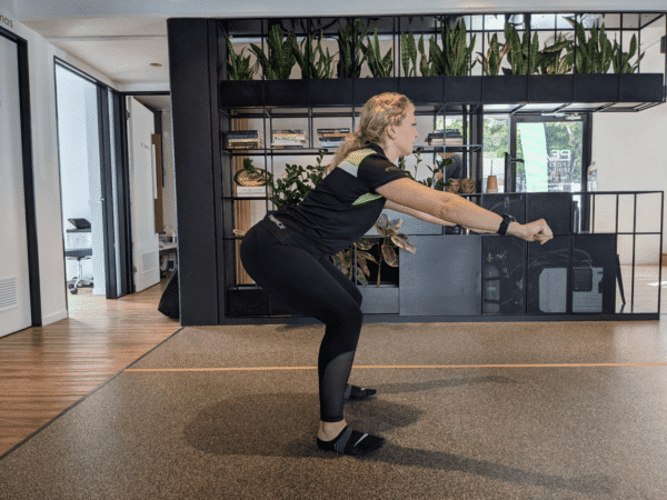 Shallow squat demonstrating reduced ankle mobility caused by stiff ankles