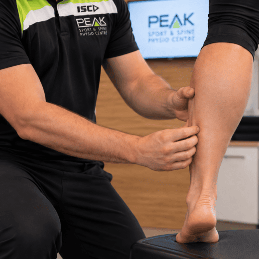 PEAK Brisbane physiotherapist testing single-leg calf raise capacity after a calf muscle strain