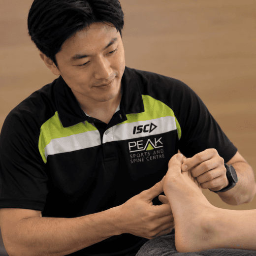 PEAK Brisbane podiatrist assessing a patient's bunion and big toe alignment
